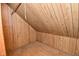 Cozy attic closet with wood paneling and a clothing rod at 2622 Ethel Ave, Indianapolis, IN 46208