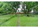 Large, fenced backyard with mature trees and grassy area at 2622 Ethel Ave, Indianapolis, IN 46208