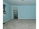 Bedroom with neutral carpet, window view, walk in closet, and soft blue walls at 2622 Ethel Ave, Indianapolis, IN 46208