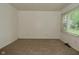 Bedroom with neutral carpet, window view and painted paneled walls at 2622 Ethel Ave, Indianapolis, IN 46208