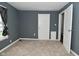 Carpeted bedroom with window and access to bathroom at 2622 Ethel Ave, Indianapolis, IN 46208