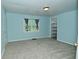 Bedroom with neutral carpet, window view, walk in closet, and soft blue walls at 2622 Ethel Ave, Indianapolis, IN 46208