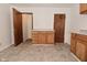 A kitchen area with a center cabinet and drawer set and access to other rooms at 2622 Ethel Ave, Indianapolis, IN 46208