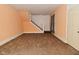 Spacious living room featuring a staircase and neutral colored walls with carpet flooring at 2622 Ethel Ave, Indianapolis, IN 46208