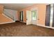 Cozy living room with neutral paint, carpet flooring, and staircase access at 2622 Ethel Ave, Indianapolis, IN 46208