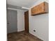 Small room area with painted block wall and utility door, and a cabinet on the wall at 2622 Ethel Ave, Indianapolis, IN 46208