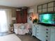 Living room with comfortable white chair, rustic decor, and a television at 2931 Eagles Crest Cir, Indianapolis, IN 46214