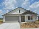 Charming single-Gathering home featuring a two-car garage, neutral siding, and a cozy front porch at 3292 W Longbranch Dr, Monrovia, IN 46157