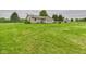 A sprawling backyard featuring a well-maintained lawn, storage shed, and partial fence at 3387 S County Road 250 W, Danville, IN 46122