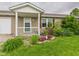Charming home exterior with a covered front porch, complemented by flowering shrubs and landscaped details at 3387 S County Road 250 W, Danville, IN 46122