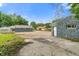 Wide backyard featuring a mixture of concrete and greenery under a bright, sunny sky at 3735 Marrison Pl, Indianapolis, IN 46205