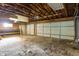 Unfinished basement with overhead lighting and large garage doors at 3735 Marrison Pl, Indianapolis, IN 46205