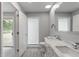 Bright bathroom with modern double vanity, wood-look floors, and a frosted glass shower at 3735 Marrison Pl, Indianapolis, IN 46205