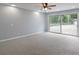 Bright bedroom with carpet, a ceiling fan, and sliding glass doors offering a view to the backyard at 3735 Marrison Pl, Indianapolis, IN 46205