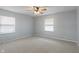 Spacious bedroom featuring two windows, a ceiling fan, and neutral carpeting at 3735 Marrison Pl, Indianapolis, IN 46205