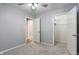 Cozy bedroom with a ceiling fan, neutral carpet, closet, and access to additional rooms at 3735 Marrison Pl, Indianapolis, IN 46205