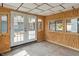 Enclosed porch with natural wood trim and windows overlooking the backyard at 3735 Marrison Pl, Indianapolis, IN 46205