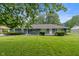 Charming single-story home featuring blue brick exterior and well-manicured lawn at 3735 Marrison Pl, Indianapolis, IN 46205
