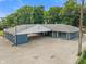 Single-story home boasting a large parking area under a gable roof, surrounded by lush trees, creating a serene setting at 3735 Marrison Pl, Indianapolis, IN 46205