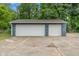 Two-car garage features stone pillars and white garage doors at 3735 Marrison Pl, Indianapolis, IN 46205