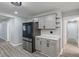 Updated kitchen with stainless steel fridge, gray cabinets, and modern lighting at 3735 Marrison Pl, Indianapolis, IN 46205