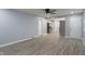 Open living area with gray walls and vinyl flooring showcases the kitchen and entry door at 3735 Marrison Pl, Indianapolis, IN 46205