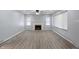 Bright living room featuring light gray walls, ceiling fan, and fireplace at 3735 Marrison Pl, Indianapolis, IN 46205