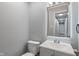 Modern powder room with a gray vanity, toilet, light-up mirror, and neutral walls at 3735 Marrison Pl, Indianapolis, IN 46205