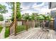 Cozy back deck with wooden flooring and railing, featuring a chair and view of the fenced backyard at 3764 Ruckle St, Indianapolis, IN 46205