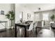 Modern dining area with stylish table and chairs, hardwood floors, leading to a cozy living room at 3764 Ruckle St, Indianapolis, IN 46205