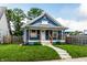Charming blue home featuring a quaint front porch, well-maintained lawn, and welcoming curb appeal at 3764 Ruckle St, Indianapolis, IN 46205