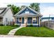 Charming blue home featuring a quaint front porch, well-maintained lawn, and welcoming curb appeal at 3764 Ruckle St, Indianapolis, IN 46205