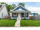 Charming blue home featuring a quaint front porch, well-maintained lawn, and welcoming curb appeal at 3764 Ruckle St, Indianapolis, IN 46205