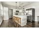 Modern kitchen featuring a center island with seating, stainless steel appliances, white cabinets, and hardwood floors at 3764 Ruckle St, Indianapolis, IN 46205