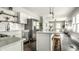Open-concept design seamlessly connecting the kitchen to the living area, enhanced by stylish pendant lights and hardwood floors at 3764 Ruckle St, Indianapolis, IN 46205