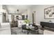 Open-concept living room with hardwood floors, stylish furnishings, and seamless flow to the dining and kitchen area at 3764 Ruckle St, Indianapolis, IN 46205