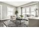 Bright living room with neutral tones, large windows, hardwood floors and comfortable seating, offering a cozy atmosphere at 3764 Ruckle St, Indianapolis, IN 46205