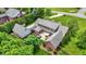 Aerial view of a brick home showcasing its expansive backyard, patio, and well-manicured landscaping at 4123 S Village Row, New Palestine, IN 46163