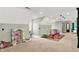 Attic featuring carpeted floors, lots of light, ceiling fans, and comfortable play area, ideal for or guests at 4123 S Village Row, New Palestine, IN 46163