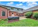 Backyard featuring a hot tub, patio with furniture, and well-manicured lawn at 4123 S Village Row, New Palestine, IN 46163