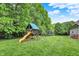 Backyard featuring a playground, trees, and trampoline at 4123 S Village Row, New Palestine, IN 46163