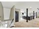 Spacious basement with dark accent pillars, carpeted floors, ample natural light, and comfortable seating areas at 4123 S Village Row, New Palestine, IN 46163