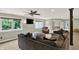 Cozy basement with comfortable seating, natural light, ceiling fan, and television for relaxation and entertainment at 4123 S Village Row, New Palestine, IN 46163