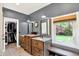 Dual sinks, natural light, and a closet highlight this bathroom at 4123 S Village Row, New Palestine, IN 46163