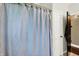Bathroom featuring patterned shower curtain and entry door at 4123 S Village Row, New Palestine, IN 46163