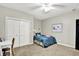Charming bedroom featuring a ceiling fan, carpet floors, and closet for storage at 4123 S Village Row, New Palestine, IN 46163