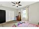 Comfortable bedroom features a ceiling fan, closet, and a bright window at 4123 S Village Row, New Palestine, IN 46163