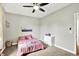 Cozy bedroom featuring a ceiling fan, carpet floors, and a bright atmosphere at 4123 S Village Row, New Palestine, IN 46163