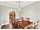 Charming dining room with hardwood floors and wooden table with seating for six at 4123 S Village Row, New Palestine, IN 46163