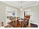 Elegant dining room with hardwood floors that opens to living room and kitchen at 4123 S Village Row, New Palestine, IN 46163